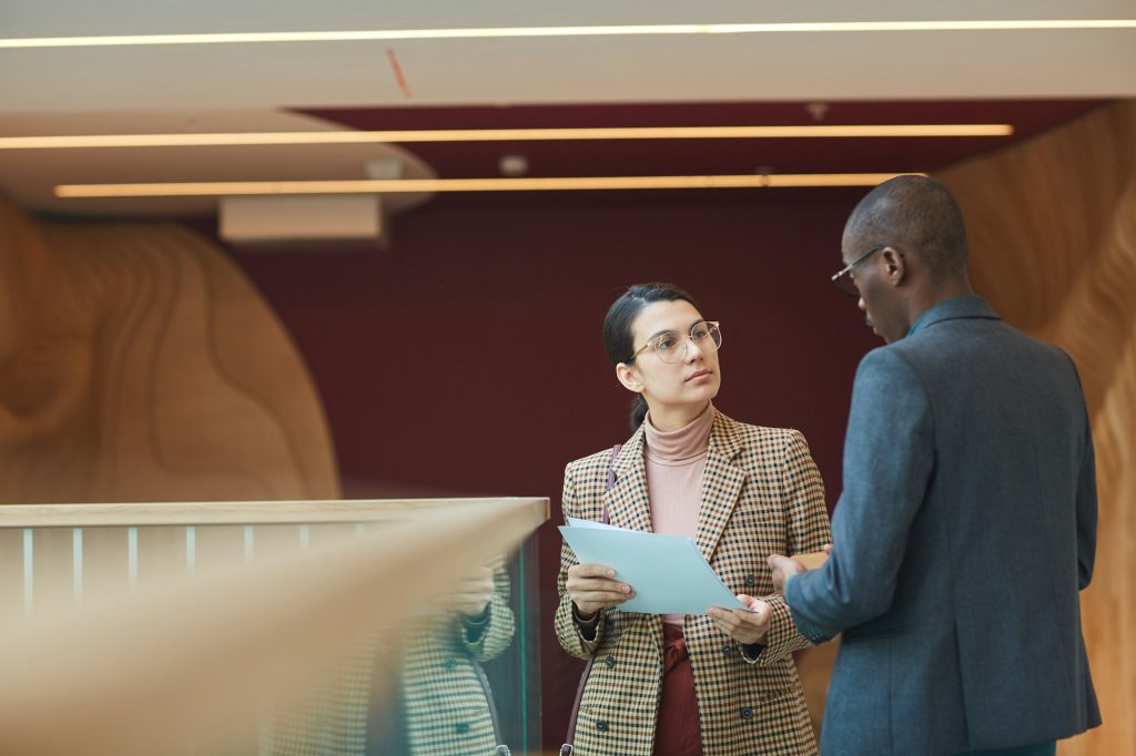 Businesswoman consulting with businessman at office